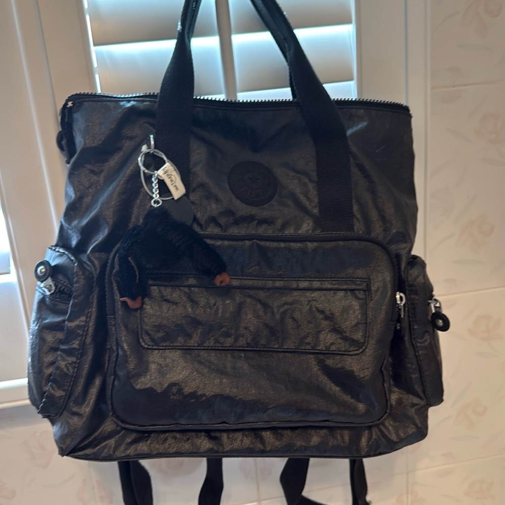 Used only two times, a convertible backpack / carry bag in a metallic black.